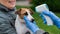The veterinarian measures the temperature of the dog with a non-contact infrared thermometer outdoors