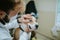 A veterinarian with a protective mask examines the dog`s eye