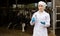 Veterinarian standing with test bottle