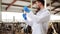 Veterinarian with syringe vaccinating cows on farm