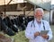 Veterinarian with tablet in front of cows in barn