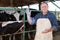 Veterinarian wears long glove to inspect cows