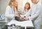 Veterinarians examine a cat on a table in a veterinary clinic. Four veterinary clinic doctors with a stethoscope