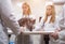 Veterinarians examine a cat on a table in a veterinary clinic. Four veterinary clinic doctors with a stethoscope