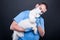Veterinary holding or examining white bichon dog