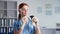 veterinary medicine, young female medical worker examines pet and smears reagent on nose of side rat in clinic office