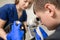 Veterinary, ophthalmologists examine the injured eye of a dog with a slit lamp in a veterinary clinic