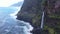 Veu da Noiva viewpoint with waterfall that flows into Ocean. Madeira island.