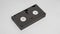 VHS videotape in dark gray box on white background, back view