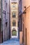 The Via degli Aranci, a narrow - alleway street with old bricks walls in the city center of Ancona, Italy