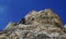 Via ferrata climber on a rock top view