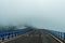 Viaduct with three lanes that are lost in the background in the fog, dangerous traffic