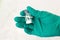 Vial with white powder of medicine, vaccine or poison in hand in sterile glove