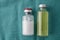 Vials of different size on green cloth