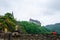 Vianden, Luxembourg - July 27, 2019: Vianden Castle on a hill with a bridge, a restaurant and Our river in Vianden, Luxembourg