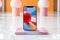 Vibrant Abstract: Smartphone Showcase on Polished Marble Floor