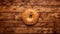 Vibrant Aerial Photography Of A Large Bagel On A Wooden Table