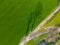 Vibrant Aerial View of Farm Tracks on Green Field