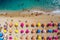 A vibrant aerial view of a sandy beach with turquoise waters and colorful sun umbrellas. Generative AI
