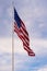 Vibrant American flag gently waving in the wind, with a crisp, clear blue sky in the background