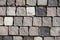 Vibrant array of hued stones are neatly stacked on a city sidewalk