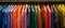 Vibrant Assortment Of Shirts Thoughtfully Organized On A Hanging Rack