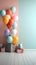 Vibrant birthday room wall, featuring gift boxes and a lively cluster of inflatable balloons.