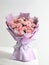 Vibrant bouquet of pink and white carnations and roses arranged against a white background