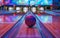 Vibrant bowling alley with a red and blue swirling bowling ball, illuminated lanes, and colorful backdrop.