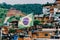 Vibrant Brazilian flag waving in the foreground of a favela in Brazil.