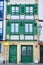 Vibrant building with green windows and balconies downtown in Hondarribia, Basque Country, Spain. Vertical photo