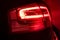 Vibrant and captivating sight of a vehicle's rear lights glowing red in the dark