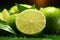 Vibrant Citrus Fresh lime slice with a water drop, green background