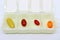 Vibrant Color Assorted Supplement Pills in an Opened White Daily Pill Organizer Case