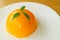 Vibrant Color Mandarin Orange Cake Dome on a White Plate