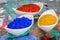 Vibrant color pigments in porcelain bowls on a palette