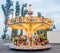Vibrant colored carousel with lights and horses, close up, outdoor near beach, seaside