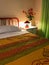 Vibrant Colored Interior of a bedroom. Pillow and colorful coverlet on the bed. Bedroom interior design
