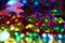 Vibrant colorful rainbow sequins close up horizontal background with bokeh