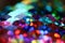 Vibrant colorful rainbow sequins close up horizontal background with bokeh