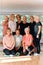 A vibrant community of senior women, guided by their instructor, embraces the enriching journey of yoga, fostering unity