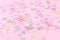 Vibrant confetti on pastel pink background