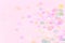 Vibrant confetti on pastel pink background