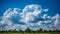 Vibrant cumulus clouds fill the blue sky in idyllic meadow generated by AI