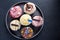 Vibrant cupcakes on plate on dark background