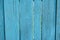 Vibrant cyan blue old wooden planking background with cracks