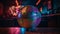 Vibrant disco ball illuminates multi colored dance floor at nightclub generated by AI