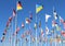 Vibrant display of European flags waving in the wind against a clear blue sky