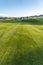 Vibrant fairway of a golf course with homes and mountain in the distance