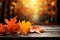 Vibrant fall leaves rest on a rustic wooden table, autumn themed